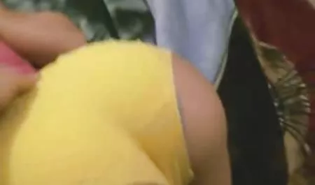 Brunette in sexy stockings sits on a chair and caresses hairy Pussy