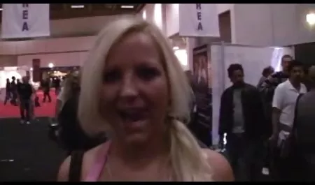 Dina sits naked on a wooden chair