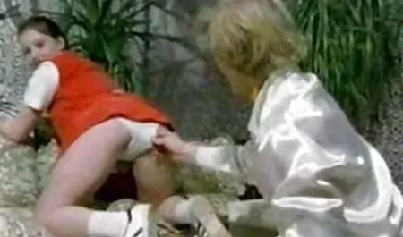 Sexy blonde with inflated breasts posing naked